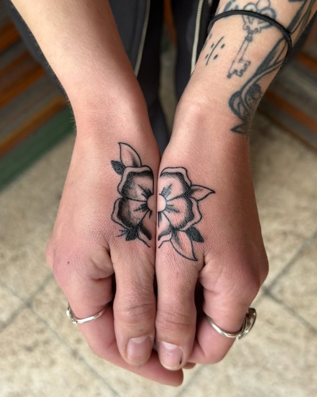 Traditional tattoo on both hands put together.
