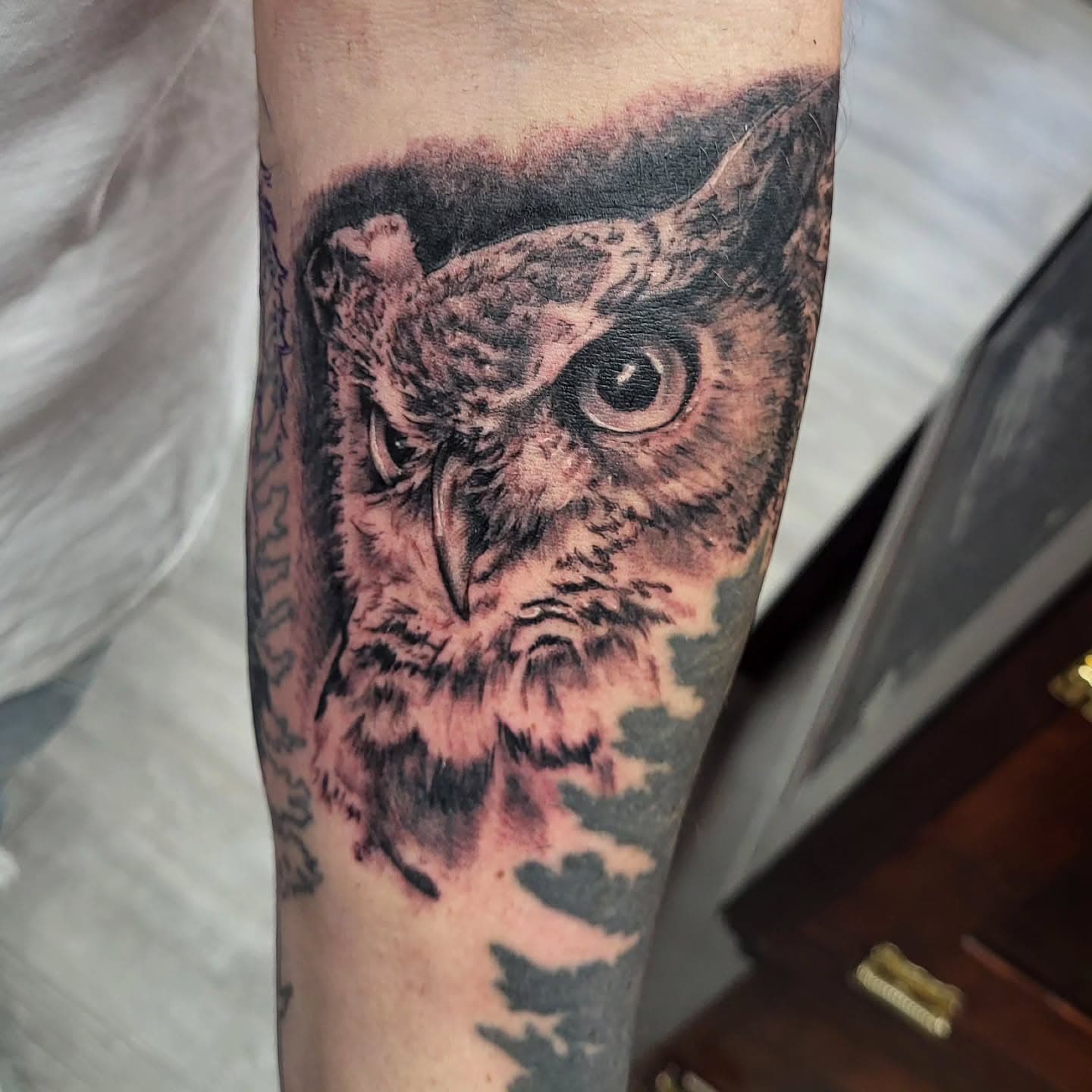 Black and white realistic tattoo of an owl